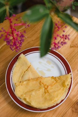 a plate of food with a tortilla on a table at Winsta Homestay in Ubud