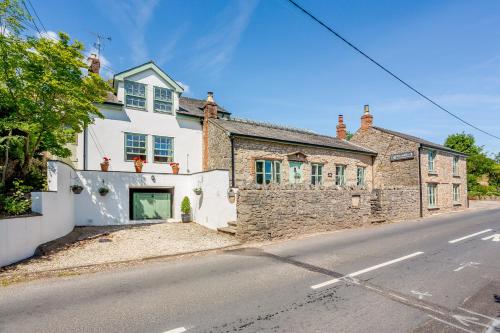 an old stone house on the side of a street at Broadrock Accommodation - Clock Cottage in Chepstow