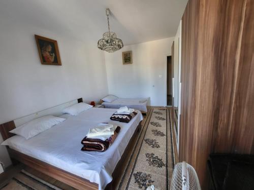 a bedroom with a bed and a chandelier at Guesthouse Gravosa in Dubrovnik