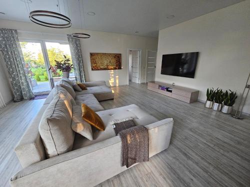 a living room with a couch and a flat screen tv at Pavilnis house in Vilnius