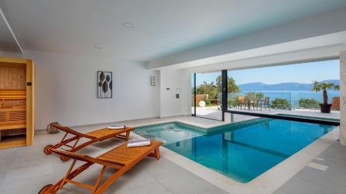 a swimming pool in a house with a view at Villa Luna Mare mit Pool und Sauna in Podaca