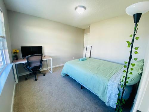 a bedroom with a bed and a desk and a chair at Spacious room with Shared bathroom in Raleigh