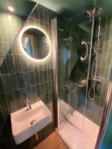 a bathroom with a sink and a shower and a mirror at ROOMS AT THE QUAYSIDE - stylish en-suite rooms on Poole Quay all fully refurbed in Poole