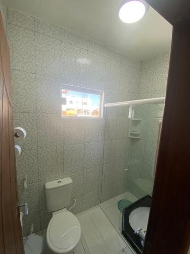 a bathroom with a toilet and a sink at Casa de Temporada Bem-Viver in Barreirinhas