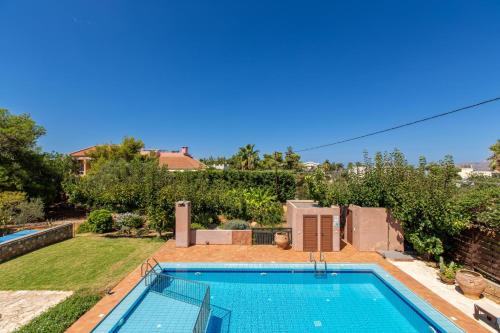 a swimming pool in the backyard of a house at Patitiri by Vintage Travel in Korakiaí