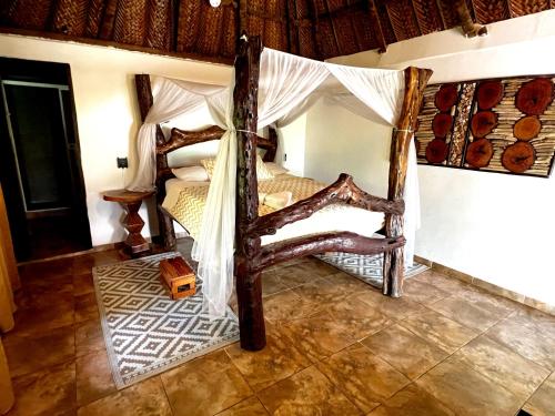 a bedroom with a bed with a canopy at Quetzal Dorado Eco-Lodge by Mareygua in El Zaino