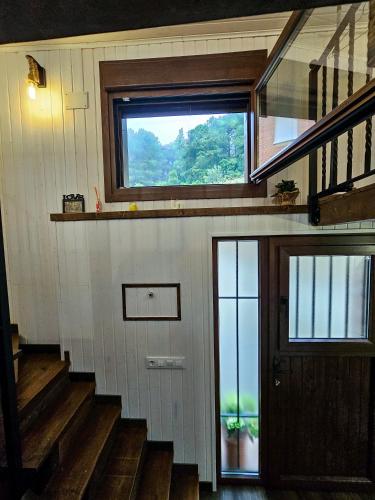 a house with stairs and a window and a door at Triana in Villarejo del Valle