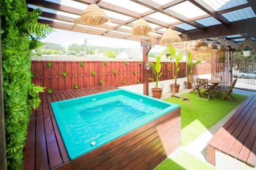a swimming pool in the middle of a yard at Encosta do Uíma - Guest House in Caldas de São Jorge