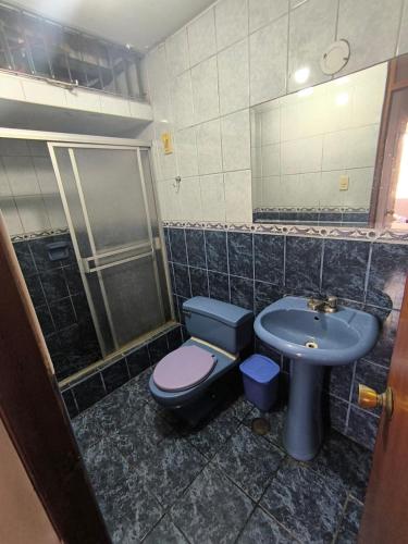 a bathroom with a toilet and a sink and a shower at Sumaq Wasi Caminos Del Inca in Lima