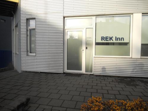 a door with a key inn sign on the side of a building at REK Inn in Reykjavík