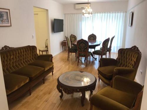 a living room with couches and a table and chairs at Departamento de categoría in Ramos Mejía