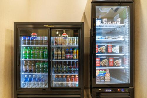 a refrigerator filled with lots of different types of drinks at Cobblestone Hotel & Suites - Alpine in Alpine