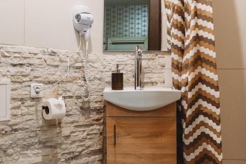 a bathroom with a sink and a mirror at Old Town Private Room, Shared Bath - D in Tallinn