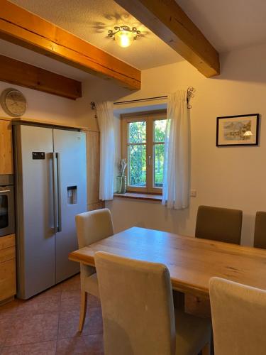 a dining room with a wooden table and chairs at Ferienwohnung Attwengerhof in Traunkirchen