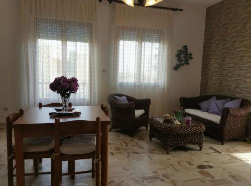 a living room with a table and chairs and a couch at App.Violet Sardegna Mare La Caletta in La Caletta