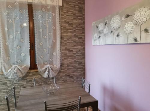 a dining room with a wooden table with chairs at App.Violet Sardegna Mare La Caletta in La Caletta