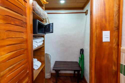 a small room with a wooden door and a table at Finca Rosa Blanca Coffee Farm and Inn in Heredia
