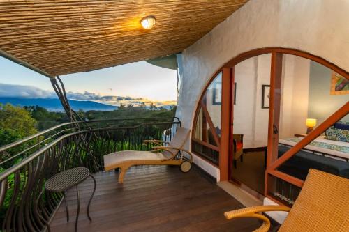 a balcony of a house with a view at Finca Rosa Blanca Coffee Farm and Inn in Heredia