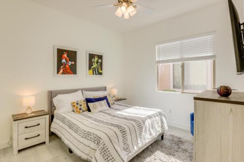 a white bedroom with a bed and a window at Pet-Friendly Indio Home with Hot Tub 55 and Community in Indio
