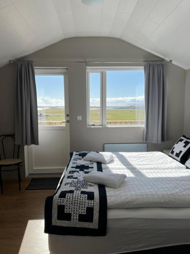 Postel nebo postele na pokoji v ubytování Sauðanes Guesthouse