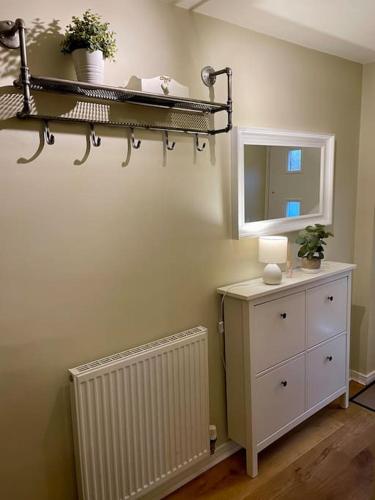 a room with a shelf and a dresser and a mirror at 3 bed house near York centre with off road parking in York