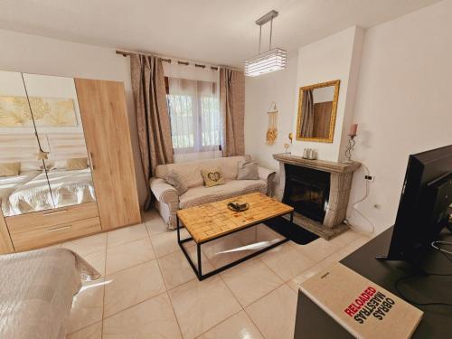 a living room with a couch and a fireplace at Villa Monika in Alpedrete