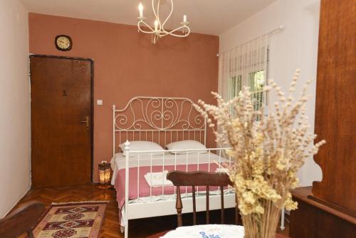 a bedroom with a bed and a vase of flowers at Villa Terrazza in Donji Morinj