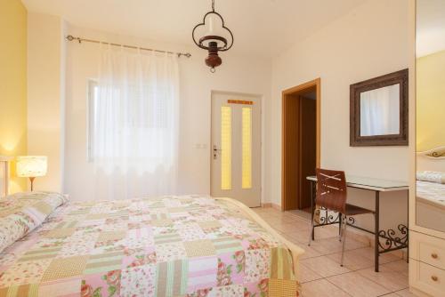 a bedroom with a bed and a table and a desk at Apartments Agneza Tucepi in Tučepi