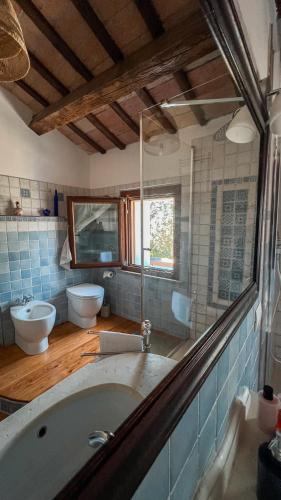 a large bathroom with a tub and two toilets at Villa Pleiadi in Casa Albonetti