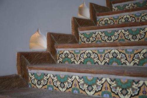 a set of stairs with colorful tiles on them at Casa 1810 Hotel Boutique in San Miguel de Allende