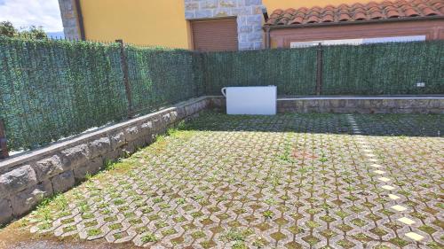 a fence in front of a house with a refrigerator at Vut "mar a poo" in poo de Llanes