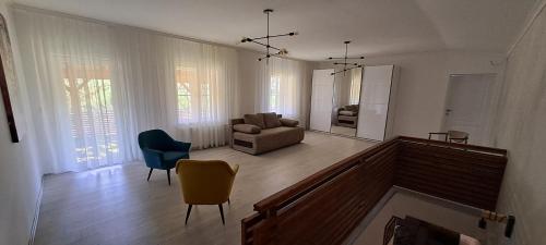 a living room with a couch and a chair at Vila Felicita in Sremski Karlovci