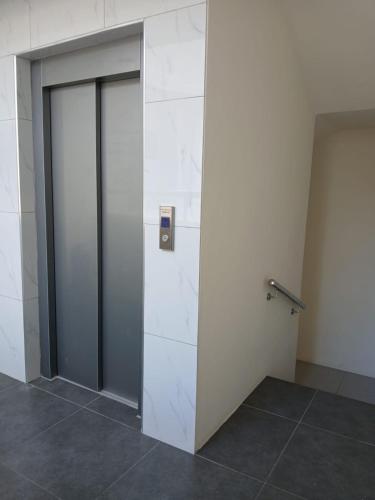a room with two glass doors and a wall at Anuya B1 in Flic-en-Flac