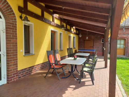 a patio with tables and chairs and a building at Ferienwohnung Hofapartment in Milkersdorf