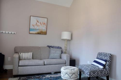 a living room with a couch and a chair at Harbor Master Villa in Ottawa