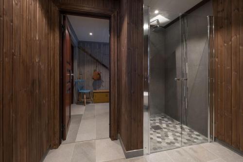 a hallway with a walk in shower and a glass door at Family Lodge in Stryn in Stryn