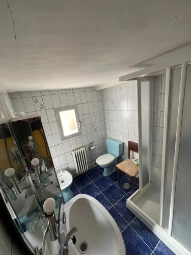 a bathroom with a sink and a toilet and a mirror at Casa Rural La Atalaya in Montarrón