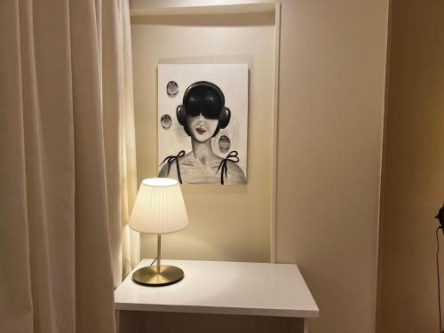 a lamp on a table with a picture of a woman at Queen Nefertari in Cairo