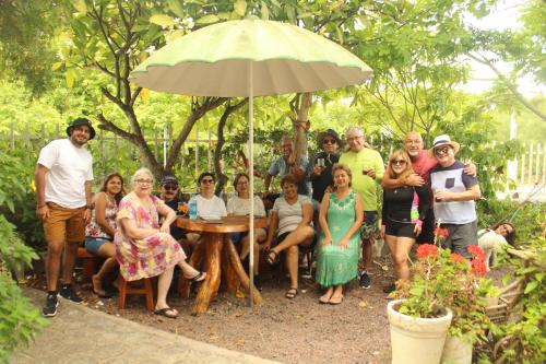 a group of people posing for a picture under an umbrella at Casa de Nelly in Puerto Baquerizo Moreno