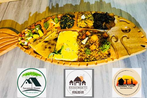 a plate of food on a table with stickers on it at Serengeti Villa in Arusha