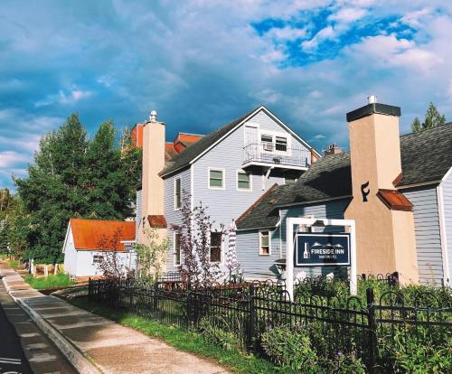 a white house with a sign in front of it at Fireside Inn & Hostel in Breckenridge