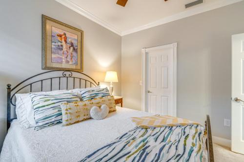 a bedroom with a bed and a picture on the wall at North Fort Myers Home with Heated Pool and Lake Views! in North Fort Myers
