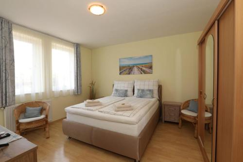 a bedroom with a large bed and a desk at Villa Nova in Hévíz
