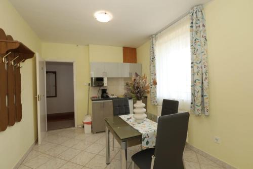 a kitchen and dining room with a table and chairs at Villa Nova in Hévíz