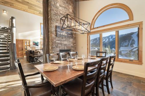 a dining room with a table and chairs and a large window at Dreamcatcher at Lakota home in Winter Park