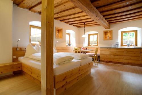 a bedroom with a large wooden bed in a room at Frühstückspension Zippo in Greifenburg