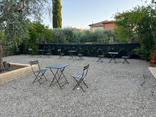 a group of tables and chairs in a courtyard at Montecristo B&B in Grosseto
