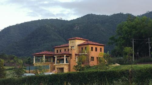 an old house in the middle of a field at Private Pool Villa & Golf - Toscana House Khaoyai 4 Bedrooms 10 Guests in Ban Rai Khlong Sai