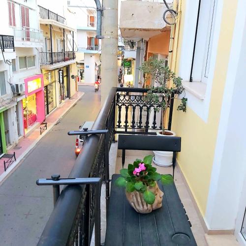a balcony with a potted plant on a railing at SITIA CITY CENTER luxury apartment in Sitia