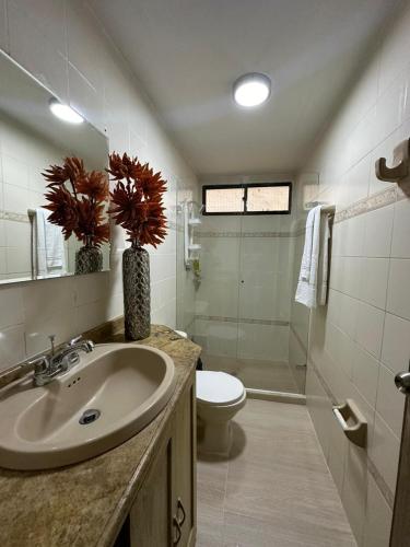 a bathroom with a sink and a toilet and a shower at Our House in Santa Marta